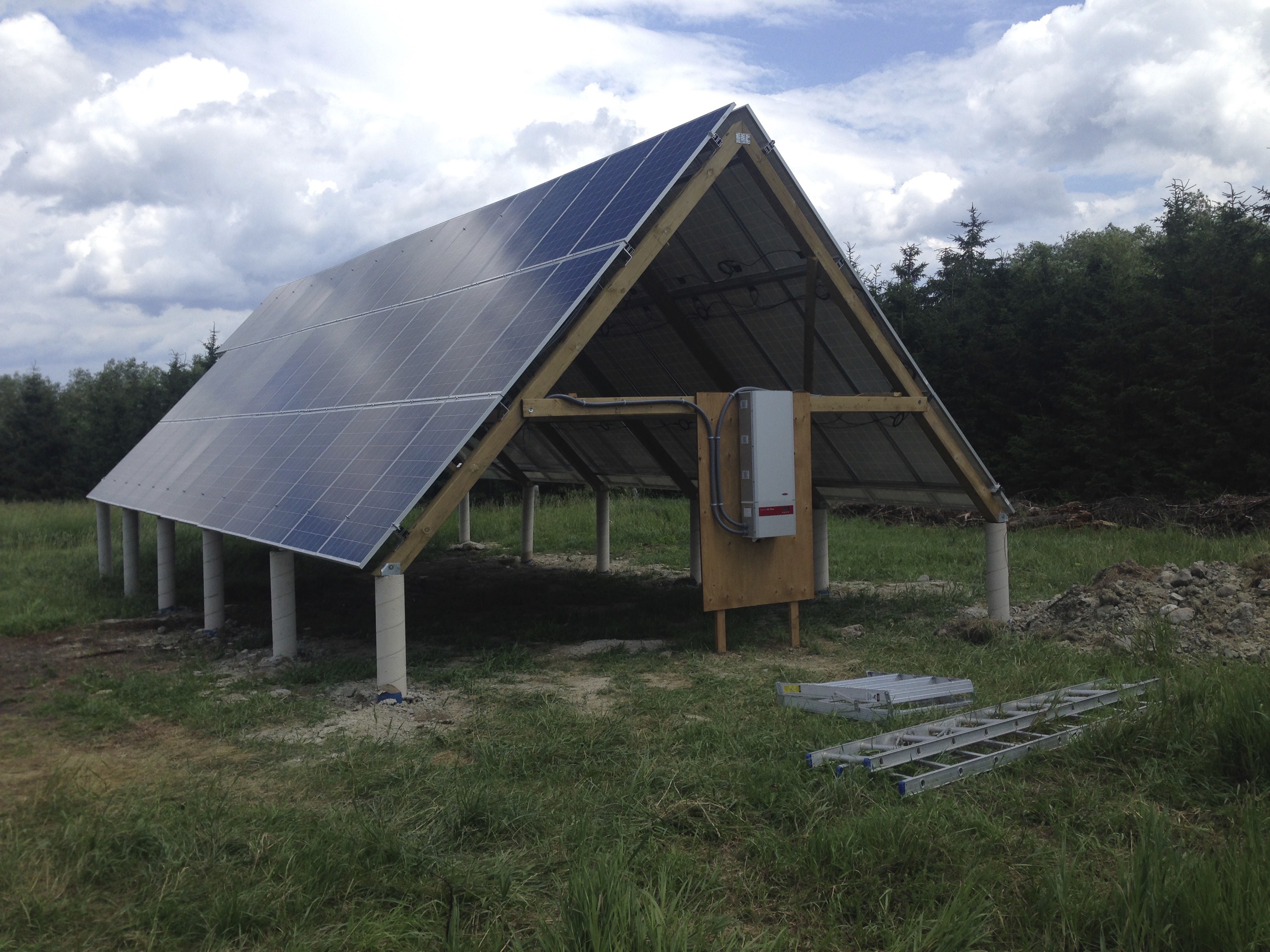 The meme is a photo of a solar panel installation in a rural area, with a sign in the foreground that reads "Solar Panel: 1.5kW, 2.5kW, 3.5kW, 4.5kW, 5.5kW...". The image is humorous because it implies that the solar panel installation is trying to be too efficient and is actually a bit too powerful for its own good.